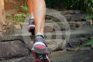 Close-up of female feet in sneakers walking outdoors