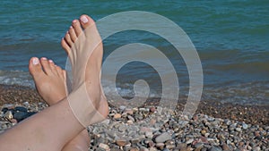 Close up of female foot with beautiful natural pink elegant pedicure.