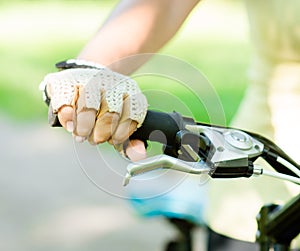 Close up female hand on bicycle handlebar