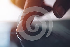 Close up of female finger pushing digital tablet touch screen