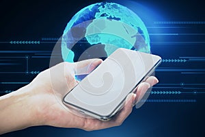 Close up of female hand holding cellphone with bright blue globe hologram and lines on blurry dark background. Metaverse, digital