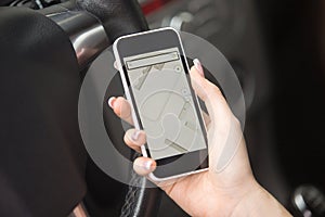 Close-up of female hand holding phone with navigation map