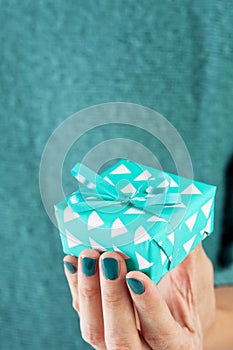 Close-up of female hand holding a present or gift