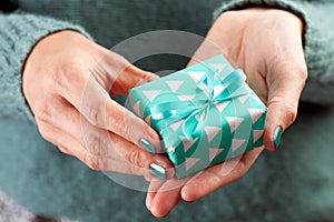 Close-up of female hand holding a present or gift