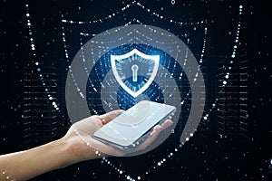 Close up of female hand holding smartphone with glowing polygonal web security shield hologram on dark background. Digital