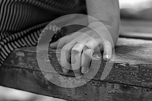 Close-up of a female hand on a park bench