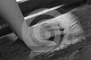 Close-up of a female hand on a park bench