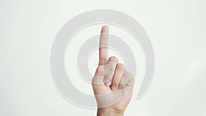 Close up of female hand shows index finger up isolated on white background