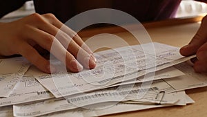 Close-up: Female hand thumb through billing accounts (HD)