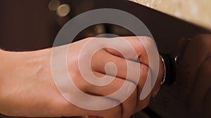 Close up of female hand turning the cooktop button of an electrical oven on. Concept. Modern kitchen utensils for food