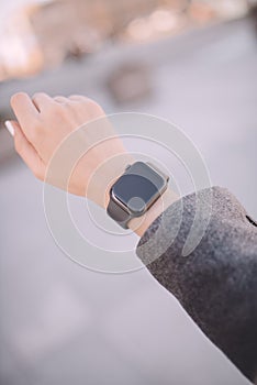 Close-up of female hand, wearing in digital smart watch