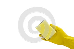Close up of female hand in yellow protective rubber glove holding green cleaning sponge against.