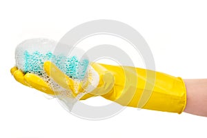 Close up of female hand in yellow protective rubber glove holding green cleaning sponge in foam