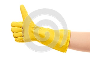 Close up of female hand in yellow protective rubber glove showing thumbs up sign