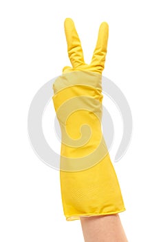 Close up of female hand in yellow protective rubber glove showing victory sign