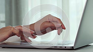 Close-up female hands of business woman typing on keyboard of laptop computer