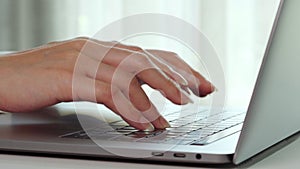 Close-up female hands of business woman typing on keyboard of laptop computer