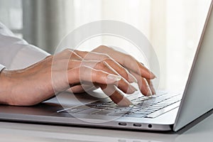 Close-up female hands of business woman typing on keyboard of laptop computer