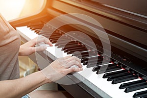 Close up female hands on chord piano