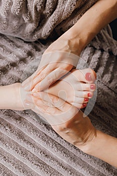 Close-up of female hands doing foot massage