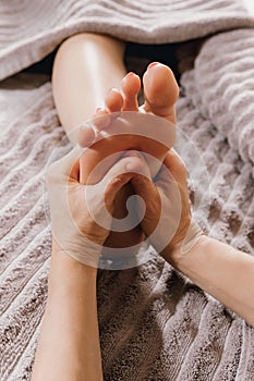 Close-up of female hands doing foot massage