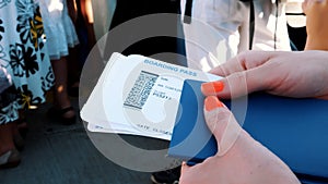 Close-up, female hands holding Airline boarding pass tickets, Boarding pass and passport at airport