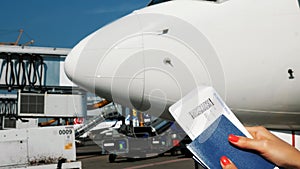 Close-up, female hands holding Airline boarding pass tickets, Boarding pass and passport at airport, on the background