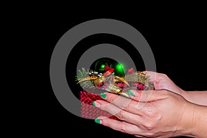 Close-up of female hands are holding a small gift. A small present for Christmas, New Year in the hands.