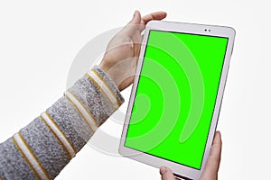 Close-up of female hands holding a tablet with an Chroma key screen for text or image. Concept of technology