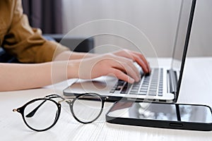 Close up of female hands on laptop keyboard, woman working in office. Caucasian female using computer at home. Business, freelance