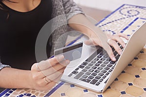 Close up of female hands making online payment.Woman sitting at