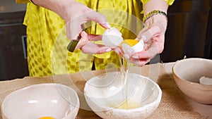 Close-up of female hands preparing dough for tasty cakes with raisins and dried fruits in kitchens. Easter holiday