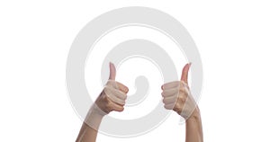 Close-up of female hands raising a thumb up on a white background. Isolated.