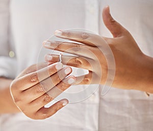 Close up of female hands removing wedding ring. Woman taking off ring after her divorce. Woman breaking off engagement