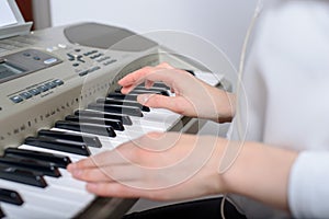 Close-up of female hands with sequencer