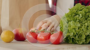 Close up female hands takes purchases refresh nutriment products in bags from grocery ecological supermarket. Unknown