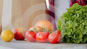 Close up female hands takes purchases refresh nutriment products in bags from grocery ecological supermarket. Unknown