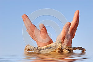 Close up of female hands tied in a rope