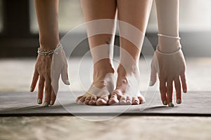 Close up of female hands touching yoga mat