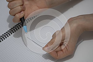 Close up of female hands traying to put graphite lead in the mechanical pencil