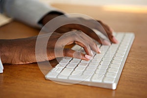 Close up female hands typing on computer keyboard photo