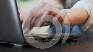 Close-up female hands typing on a laptop