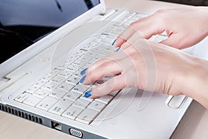 Close-Up of Female Hands Typing on Laptop Keyboard: Business and Education Concept