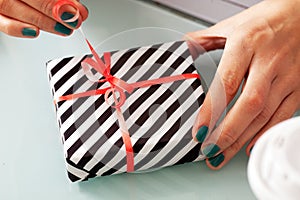 Close-up of female hands unpacking a present