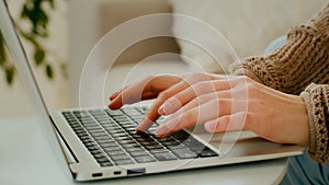 Close up female hands of unrecognizable business woman professional user worker using typing on laptop. Cropped view