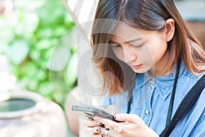 Close-up of female hands using modern smart phone while working,Young woman using a touchscreen smartphone