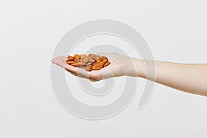 Close up female hold in hand brown unprocessed almonds nuts isolated on white background. Proper nutrition, vegan food