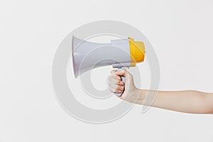 Close up female holds in hand bullhorn public address megaphone isolated on white background. Hot news, announce