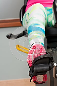 Close-up of female leg wearing sport shoe and pedaling