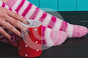 Close-up of female legs in bright colored warm socks